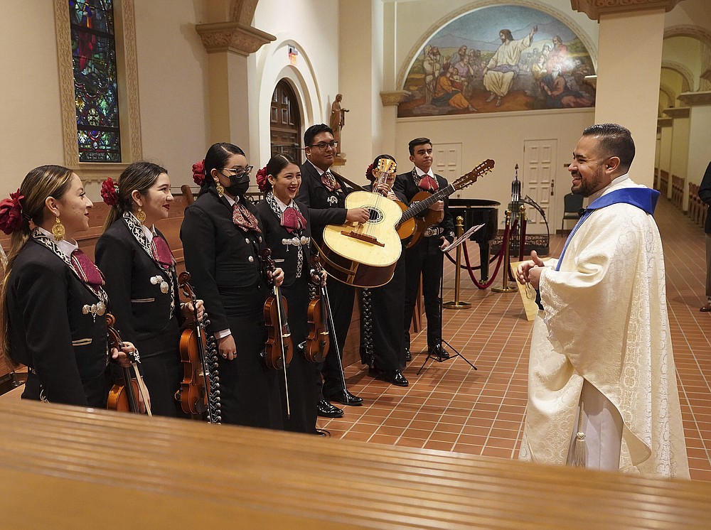 After a long absence from the rector of St. Augustine's Cathedral in Tucson, Reverend Alan Valencia once again welcomes the Mariachi band Los Changuitos Feos (Ugly Little Monkeys) as they prepare to perform at their morning mass on Sunday August 18, 2021 in downtown Tucson.  â€œSyncretism is the reality of this land, the 'ambos' reality,â€ says Valencia, the Cathedral & # x2019; s rector, who grew up attending Mariachi Mass - ambos Nogales, & # x201d;  or â€œthe two Nogales,â€ as locals refer to the two towns of the same name straddling the US-Mexico border about 60 miles (100 kilometers) to the south.  (AP Photo / Darryl Webb)