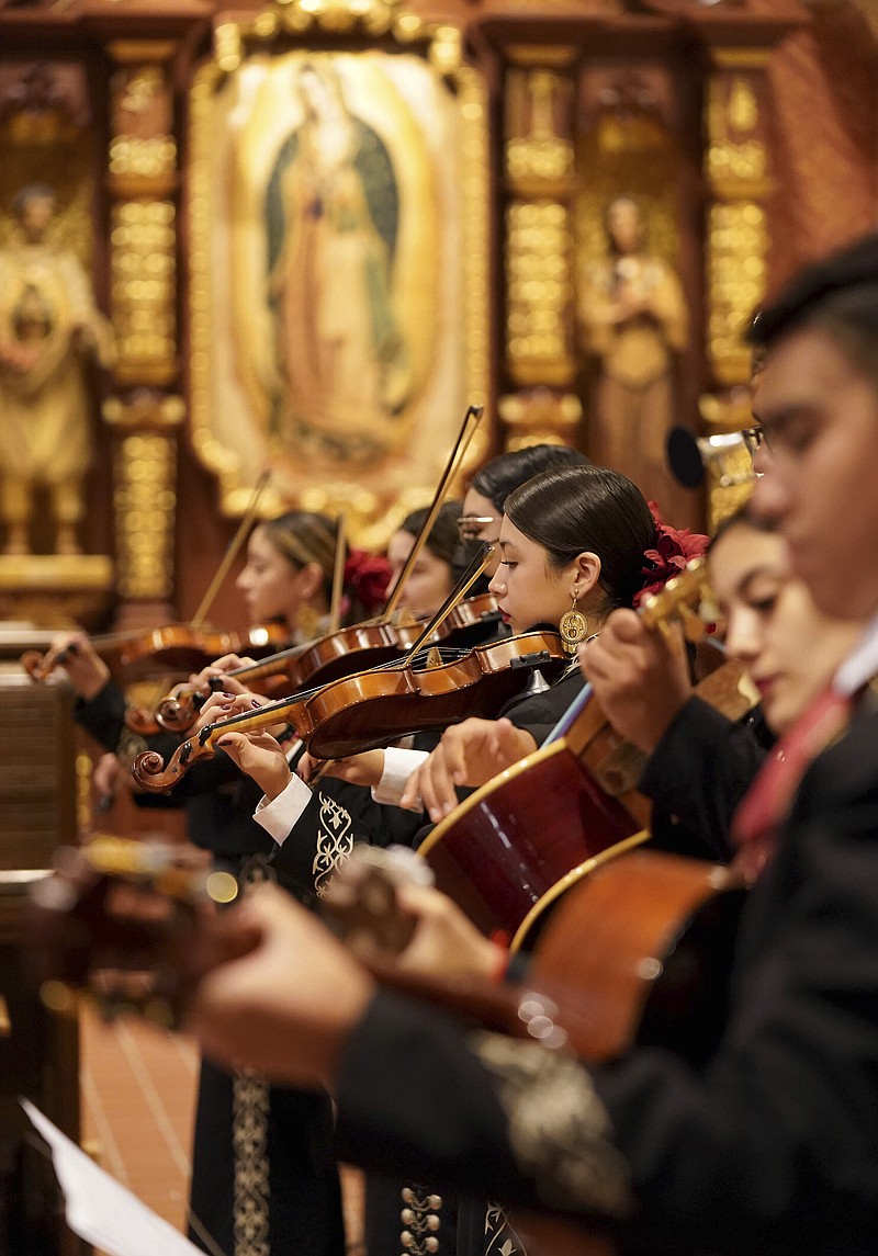 Mariachi band Los Changuitos Feos (Ugly Little Monkeys) members preform for parishioners after a morning Mass at St. Augustine Cathedral Sunday, Aug. 18, 2021 in downtown Tucson. (AP Photo/Darryl Webb)