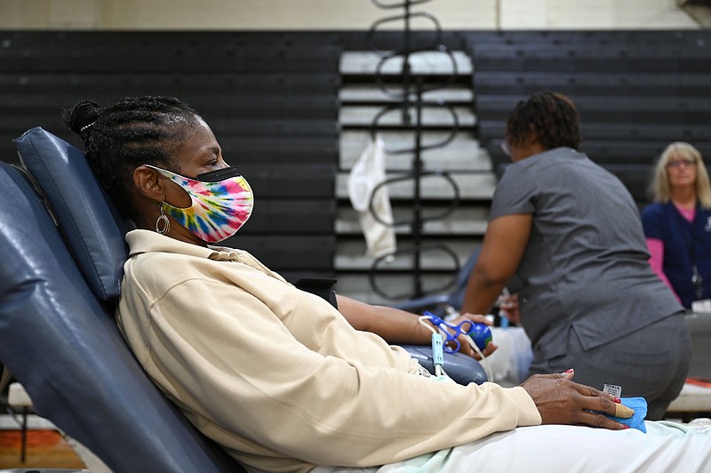 Keren Lynn Johnson prepares to donate blood during a blood drive with the Arkansas Blood Institute at Little Rock Central High School on Tuesday, July 6. (Arkansas Democrat-Gazette/Stephen Swofford)