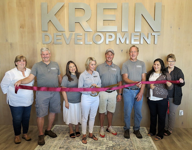 Westside Eagle Observer/RANDY MOLL
Judy Kay Krein cuts the ribbon Thursday at Krein Development's new office building at 880 S. Gentry Blvd. Judy Kay was accompanied by her husband and co-owner, Jim Krein; by employees Cristina Dominguez, Jim Wren and Denny Williams; and by Gentry Chamber of Commerce members Janie Parks, Andrea Tunn and Kristi Hollaway.