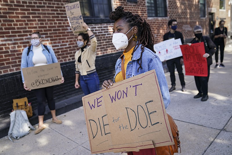 FILE - Teachers and staff protest outside Franklin D. Roosevelt High School as they call for more and better COVID-19 testing and precautions, Oct. 2, 2020, in New York. All New York City public school teachers and other staffers will have to get vaccinated against the coronavirus, officials said Monday, Aug. 23, 2021, as the nation's largest school system prepares for classes to start next month. (AP Photo/John Minchillo, File)