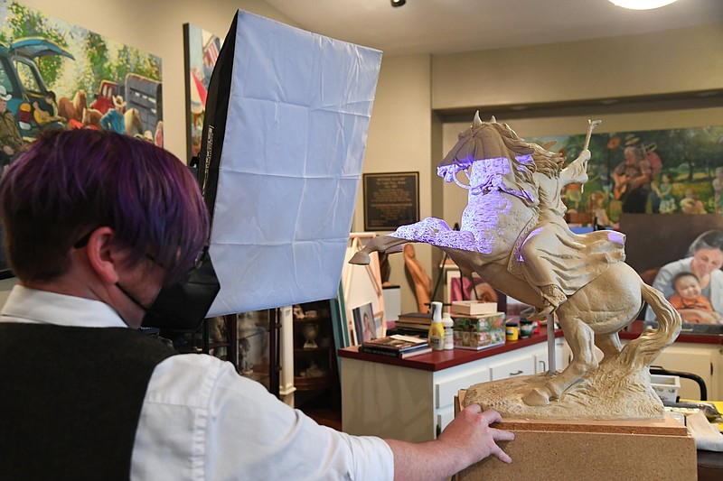 Michael Karr, Makerspace program coordinator at National Park College, performs a 3D scan of Longhua Xu’s sculpture of a Native American woman on horseback that will be used to make a mold for a 12-foot-tall version of it. - Photo by Tanner Newton of The Sentinel-Record