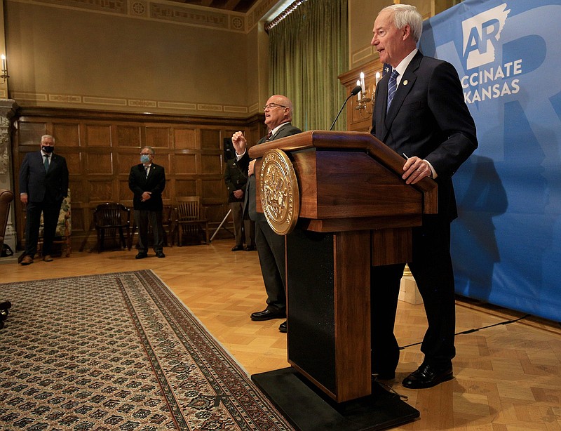 Gov. Asa Hutchinson speaks Tuesday Aug. 24, as state Secretary of Health Dr. Jose Romero, second from left, looks on, during the state's weekly COVID-19 press briefing at the state Capitol in Little Rock. (Arkansas Democrat-Gazette/Staton Breidenthal)