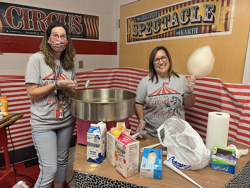 ALEXUS UNDERWOOD/SPECIAL TO MCDONALD COUNTY PRESS Pictures is Stacie Campbell and Michele Womack at the popcorn and cotton candy station. By the end of the night, Campbell could make multi-colored cotton candy flowers.