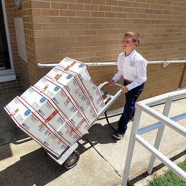 Courtesy photo
Huck Plyler prepares to send off a batch of care packages to deployed military. Huck's Military Care Package Project has delivered more than 1,000 care packages to members of the U.S. Armed Forces.