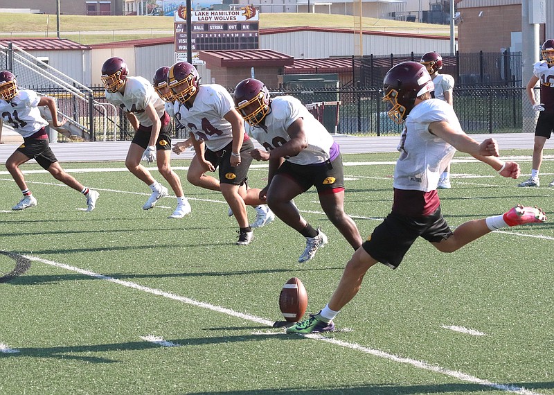 Lake Hamilton players run through drills during a recent practice at Wolf Stadium. - Photo by Richard Rasmussen of The Sentinel-Record