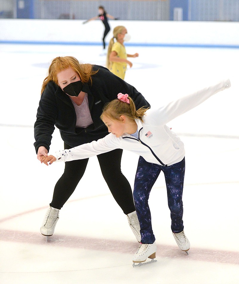 Figure skating coach Chelsea Mendenhall (left) offers instruction Thursday as Autumn Aprea, 8, of Cave Springs works on her turns during a period for private figure skating lessons at the Jones Center in Springdale. The center offers figure skating sessions throughout the week. 
(NWA Democrat-Gazette/Andy Shupe)