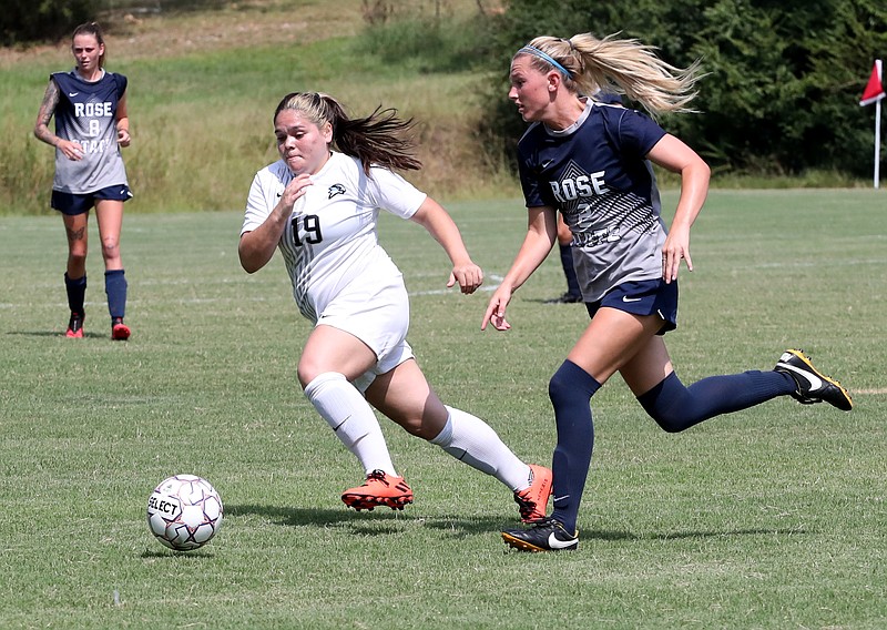 National Park's Aleandra Clark (19), left, and Rose State’s Keanna Witte (2) chase the ball during NPC's 8-0 loss Thursday. - Photo by Richard Rasmussen of The Sentinel-Record
