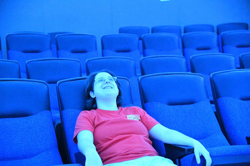 Casey Wylie, director of education at Mid-America Science Museum, sits in the Dome Theater, which will reopen in September with an updated projector system. - Photo by Tanner Newton of The Sentinel-Record