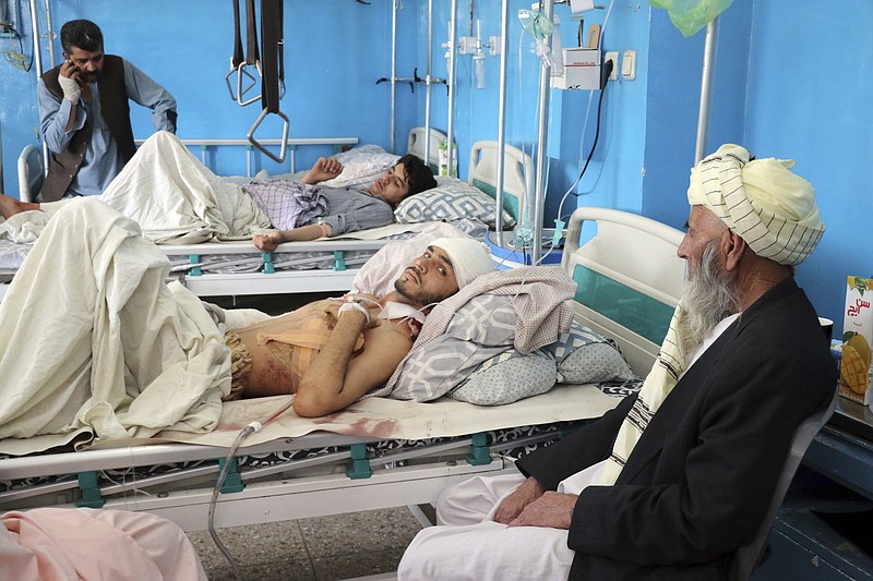 Afghans lie on beds at a hospital after they were wounded in the deadly attacks outside the airport in Kabul, Afghanistan, Friday, Aug. 27, 2021. Two suicide bombers and gunmen attacked crowds of Afghans flocking to Kabul's airport Thursday, transforming a scene of desperation into one of horror in the waning days of an airlift for those fleeing the Taliban takeover. (AP Photo/Wali Sabawoon)