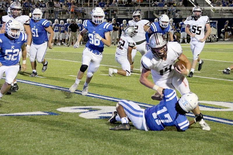 Mark Ross/Special to Siloam Sunday
Siloam Springs quarterback Hunter Talley runs over the left side as Rogers' Tye Cunningham makes the tackle during Friday's game at Whitey Smith Stadium in Rogers. The Mounties defeated the Panthers 51-40.