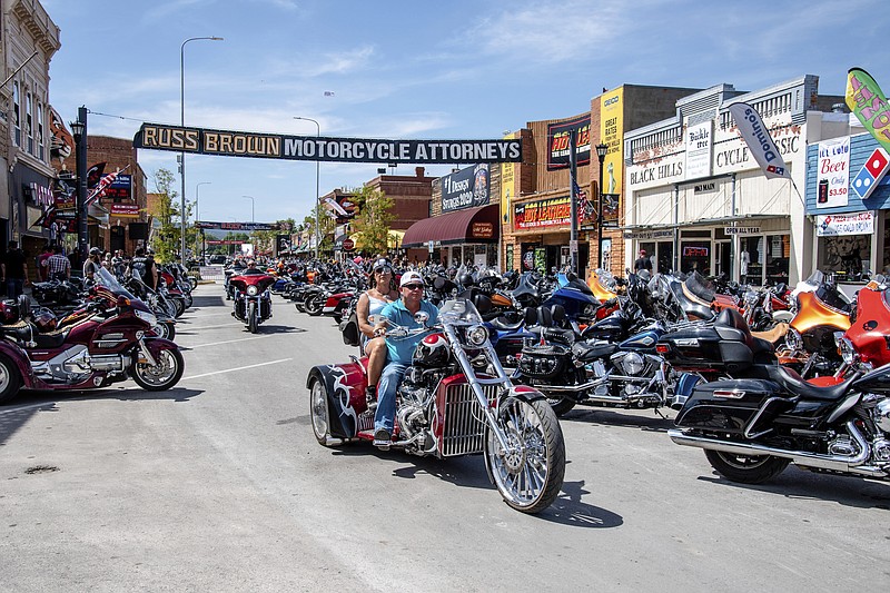 FILE - In this Saturday, Aug. 15, 2020 file photo, Bikers ride down Main Street during the 80th annual Sturgis Motorcycle Rally  in Sturgis, S.D. Health officials across five states have linked 178 virus cases to the Sturgis Motorcycle Rally. In the three weeks since the rally kicked off, coronavirus cases in South Dakota have shot up at a startling pace.  (Amy Harris/Invision/AP, File)