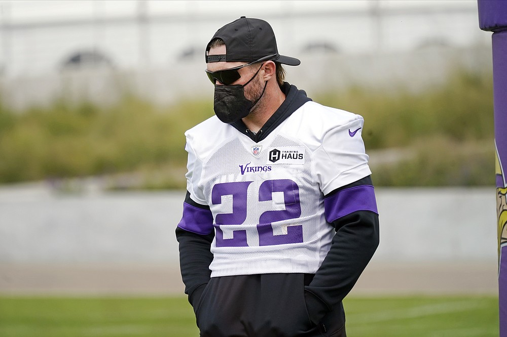 Minnesota Vikings free safety Harrison Smith (22) stands in the end zone wearing a medical face mask required by the team for unvaccinated players during the NFL football team's training camp, Thursday, Aug. 5, 2021, in Eagan, Minn. (AP Photo/Jim Mone)