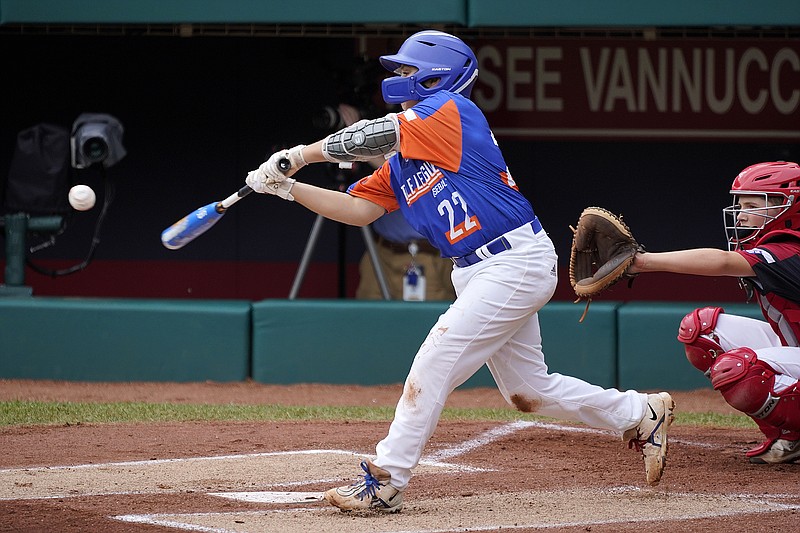 Taylor, Mich.'s Jackson Surma (22) hits a double off Hamilton, Ohio's Chance Retherford, driving in two runs, during the first inning of the Little League World Series Championship baseball game in South Williamsport, Pa., Sunday, Aug. 29, 2021. (AP Photo/Gene J. Puskar)