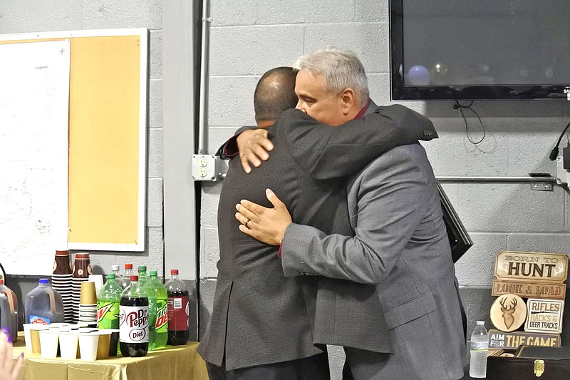 Jim Damante, the new sheriff of Crawford County, right, and outgoing Sheriff Ron Brown, left, embrace during the retirement party for Brown at the Crawford County Emergency Operations Center in Van Buren Tuesday. 
(NWA Democrat-Gazette/Thomas Saccente)