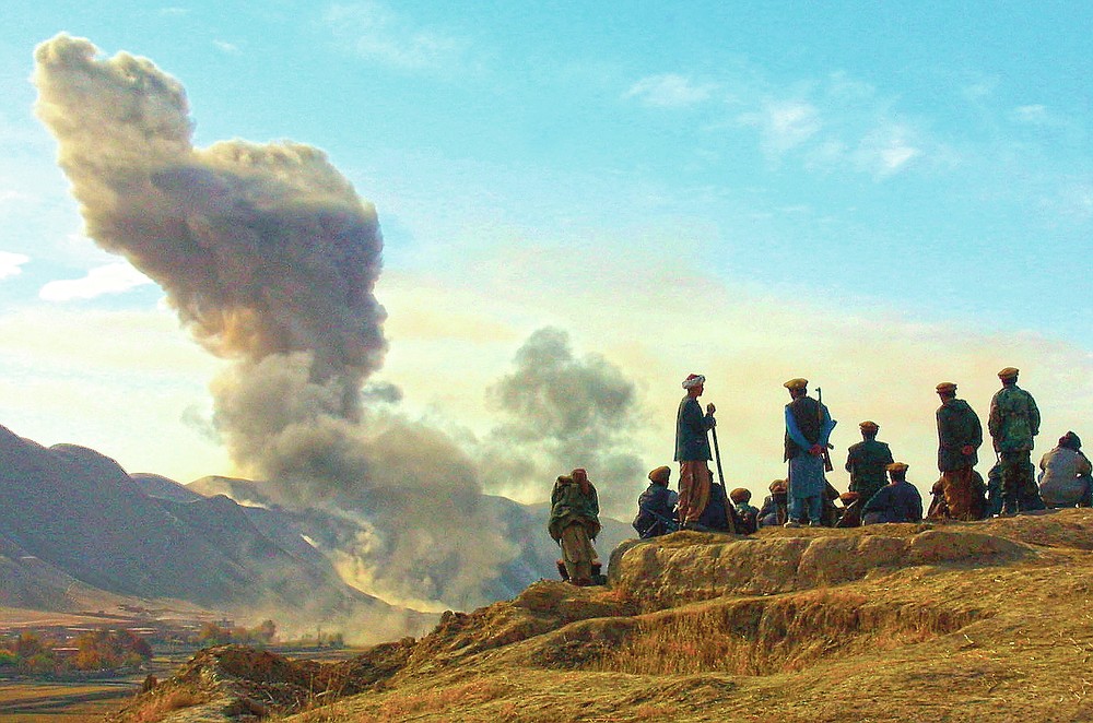 ADVANCE FOR PUBLICATION ON FRIDAY, SEPT. 10, AND THEREAFTER - FILE - In this Nov. 19, 2001 file photo, Northern Alliance soldiers watch as U.S. air strikes attack Taliban positions in Kunduz province, Afghanistan. (AP Photo/Ivan Sekretarev, File)