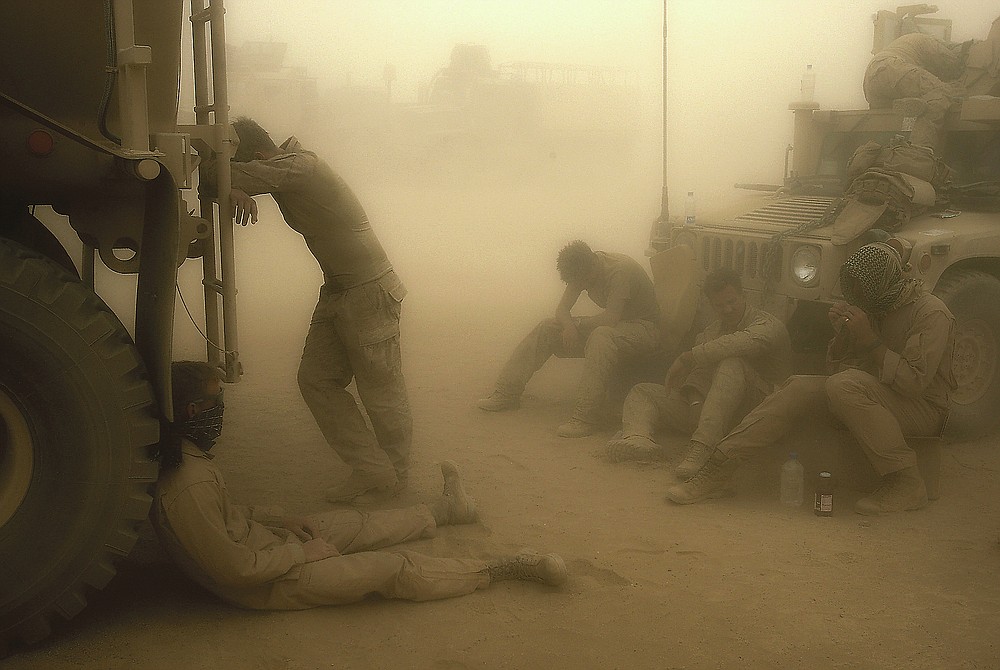 ADVANCE FOR PUBLICATION ON FRIDAY, SEPT. 10, AND THEREAFTER - FILE - In this Wednesday, May 7, 2008 file photo, U.S. Marines from the 24th Marine Expeditionary Unit try to take shelter from a sand storm at forward operating base Dwyer in the Helmand province of southern Afghanistan. (AP Photo/David Guttenfelder, File)
