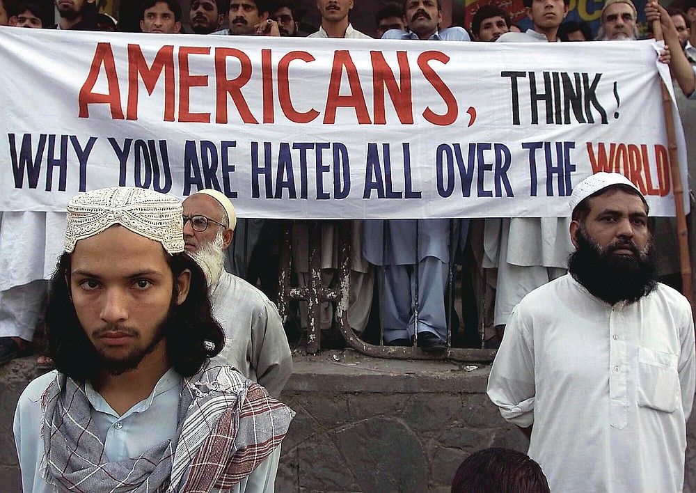 ADVANCE FOR PUBLICATION ON FRIDAY, SEPT. 10, AND THEREAFTER - FILE - In this Saturday, Sept. 15, 2001 file photo, activists of Pakistan militant religious parties stand with a banner which reads, "Americans, think why you are hated all over the world," during a rally in Islamabad, Pakistan to condemn possible U.S. attacks on neighboring Afghanistan. People are fearing here that the U.S. will attack on Afghanistan in retaliation of the attacks in New York and Washington earlier in the week. (AP Photo/B.K. Bangash, File)