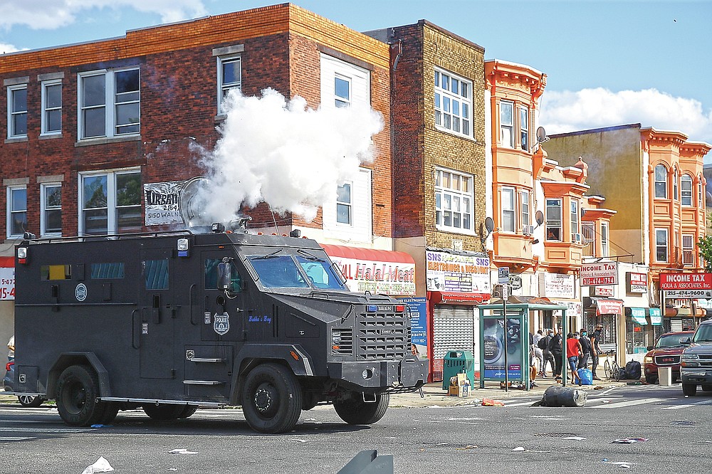ADVANCE FOR PUBLICATION ON FRIDAY, SEPT. 10, AND THEREAFTER - FILE - In this May 31, 2020 file photo, police deploy tear gas to disperse a crowd during a protest in Philadelphia over the death of George Floyd. Floyd died May 25, 2020 after he was pinned at the neck by a white Minneapolis police officer. (AP Photo/Matt Rourke, File)