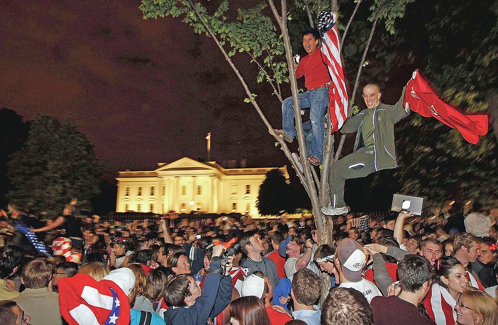ADVANCE FOR PUBLICATION ON FRIDAY, SEPT. 10, AND THEREAFTER - FILE - In this Monday, May 2, 2011 file photo, crowds climb trees and celebrate in Lafayette Park in front of the White House in Washington after President Barack Obama announced that Osama bin Laden had been killed. (AP Photo/Charles Dharapak, File)