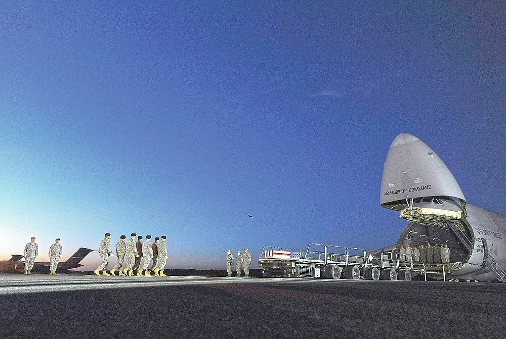 ADVANCE FOR PUBLICATION ON FRIDAY, SEPT. 10, AND THEREAFTER - An Army carry team marches toward a transfer case containing the remains of Spc. Kyle E. Gilbert at Dover Air Force Base, Del., Wednesday, Sept. 23, 2015. According to the Department of Defense, Gilbert, 24, of Buford, Ga., died in a non-combat related incident Sept. 21, 2015 in Bagram, Afghanistan. (AP Photo/Steve Ruark, File)