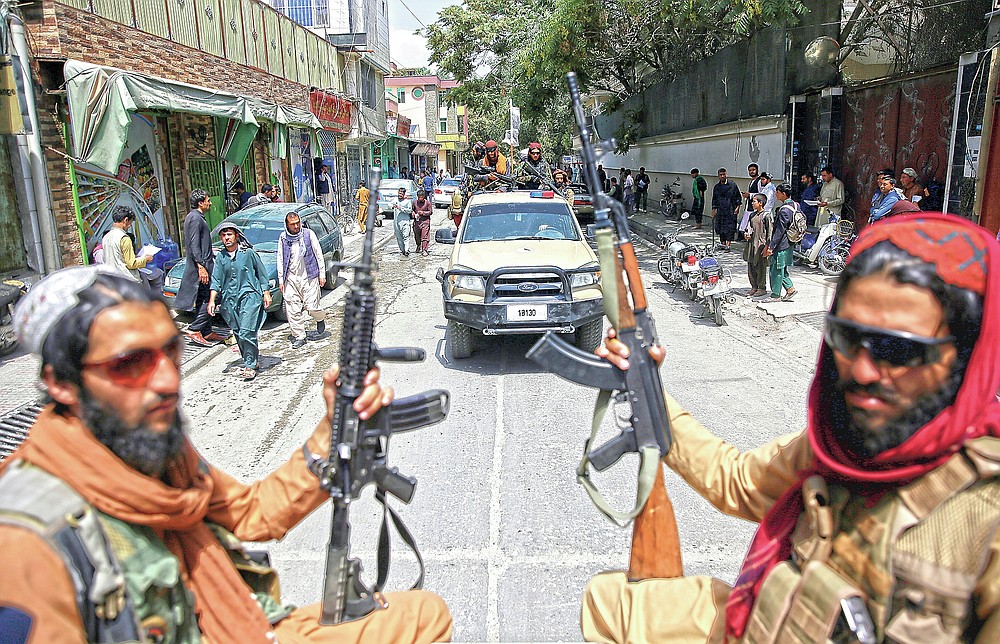 ADVANCE FOR PUBLICATION ON FRIDAY, SEPT. 10, AND THEREAFTER - FILE - In this Thursday, Aug. 19, 2021 file photo, Taliban fighters patrol Kabul, Afghanistan,. The Taliban celebrated Afghanistan's Independence Day on Thursday by declaring they beat the United States, but challenges to their rule ranging from running a country severely short on cash and bureaucrats to potentially facing an armed opposition began to emerge. (AP Photo/Rahmat Gul, File)