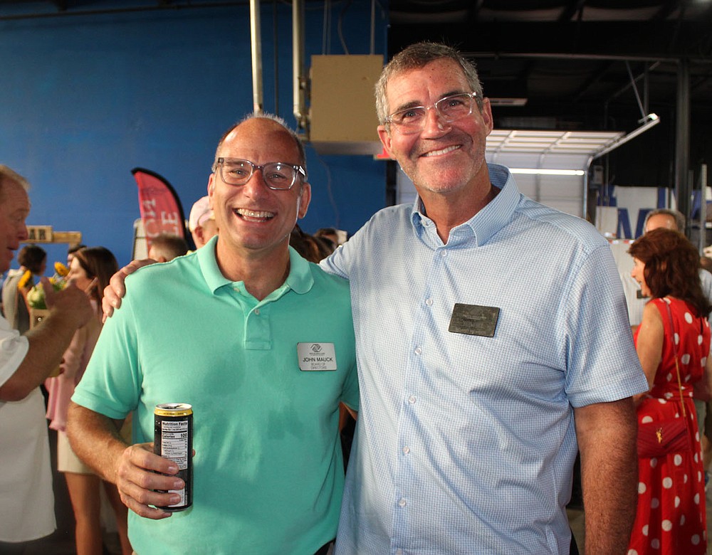 John Mauck (left) and Ted Fox, Boys & Girls Club board members, help the nonprofit organization welcome supporters to Sip & Savor on Aug. 19.
(NWA Democrat-Gazette/Carin Schoppmeyer)