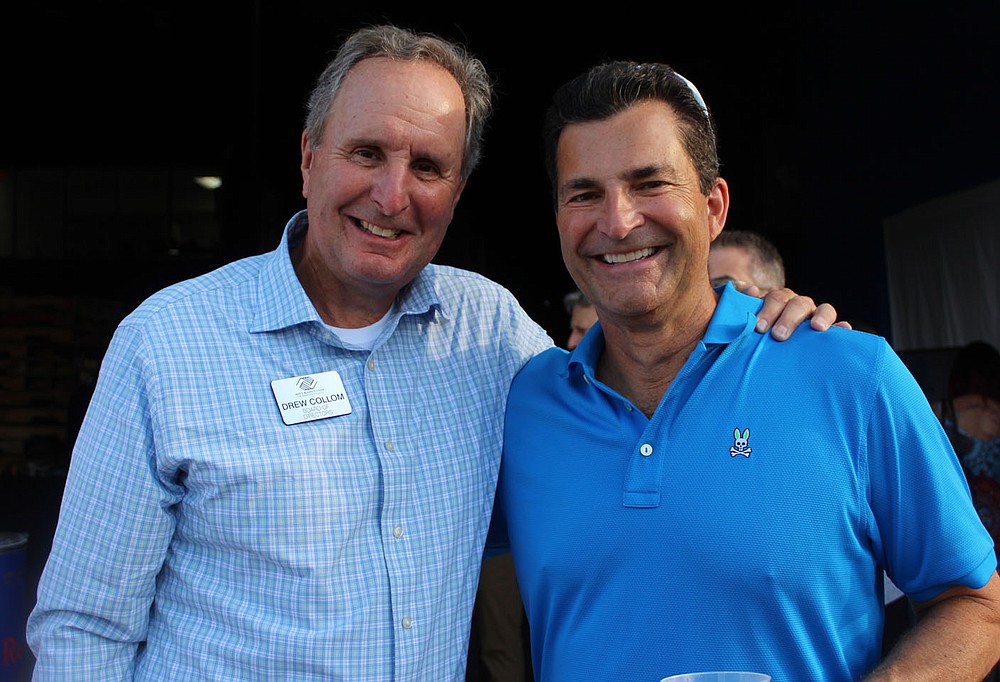 Drew Collom, Boys & Girls Club board member (left) and Todd Hanus visit at Sip & Savor.
(NWA Democrat-Gazette/Carin Schoppmeyer)