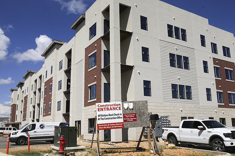 Construction is shown, Monday, August 30, 2021 at the Promenade Commons in Bentonville. The sale price of single-family homes in Benton and Washington counties soared during the first half of 2021 and apartment vacancy rates tightened up, according to the most recent Arvest Bank Skyline Report.(NWA Democrat-Gazette/Charlie Kaijo)