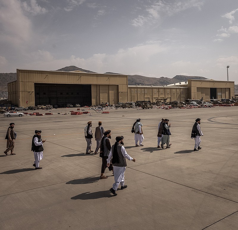 Members of the Taliban stroll around the airport Tuesday in Kabul. “Afghanistan is finally free,” Hekmatullah Wasiq, a top Taliban official, said on the tarmac. “Everything is peaceful. Everything is safe.”
(The New York Times/Jim Huylebroek)