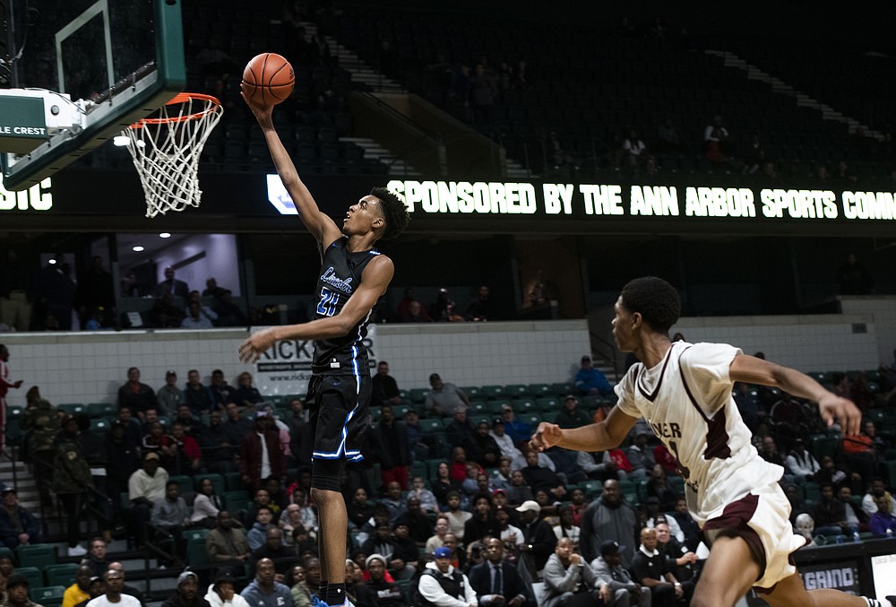 FILE - In this Dec. 9, 2019, file photo, Ypsilanti Lincoln's Emoni Bates shoots against River Rouge during the Tip Off Classic high school basketball game in Ypsilanti, Mich. Bates has committed to Memphis, adding another five-star recruit to coach Penny Hardaway's roster. Bates announced his decision Wednesday, Aug. 25, on Instagram after narrowing his choices to Michigan State, Oregon and the NBA's G League. The Michigan native committed to Tom Izzo and the Spartans last year before changing his mind in April. (Nicole Hester/Ann Arbor News via AP)