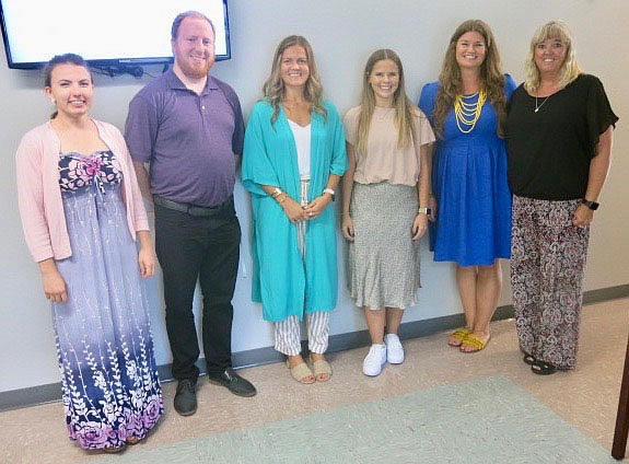 Westside Eagle Observer/SUSAN HOLLAND
Six new faculty members at Gravette schools smile for the camera after being introduced by superintendent Maribel Childress at the August 16 meeting of the Gravette school board. New hires who attended the meeting are Gabrielle Hamilton,  music teacher/interventionist at Gravette Upper Elementary; Justin Garton, theater arts teacher at Gravette High School; Samantha Luther, social studies teacher and head softball coach at Gravette High School; Emma Wisdom, PE teacher at Glenn Duffy Elementary and assistant basketball coach; Brandi Brown, art teacher/interventionist at Glenn Duffy Elementary; and Carolyn Huntsman, Title I teacher at Gravette Upper Elementary.