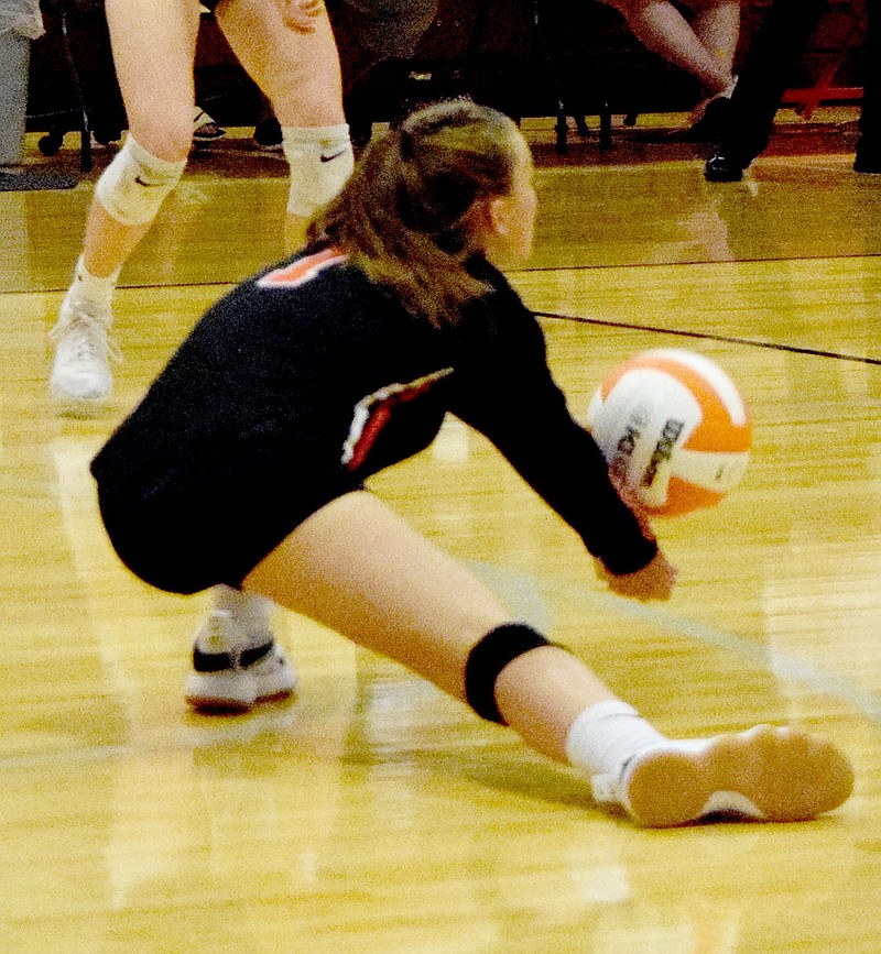 Westside Eagle Observer/MIKE ECKELS
Lady Lion Trinity Burnett intercepts a Lady Saint serve before it hits the court during the Thursday night Gravette-Shiloh Christian varsity volleyball match at the Competition Gym in Gravette. Burnett was able to send the ball back to a teammate on the front line who sent it back over the net for a Gravette point.