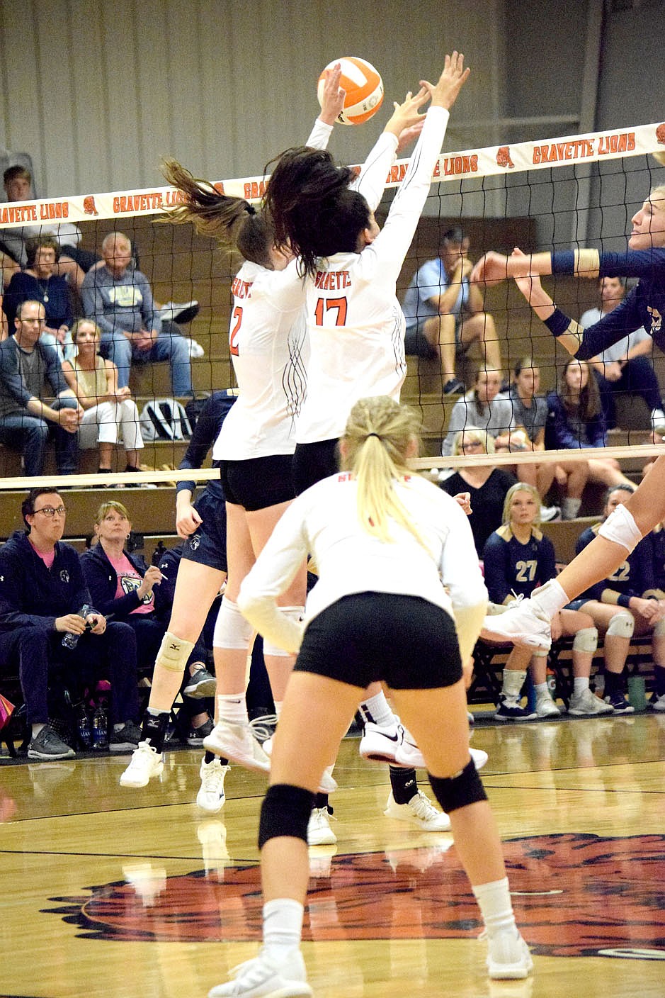 Westside Eagle Observer/MIKE ECKELS
Working as a team, Lady Lions Abby Smith (2) and Ella Pinches (17) deflect a hit back into Lady Saint territory during the third set of the Gravette-Shiloh Christian varsity volleyball match in Gravette Thursday night.