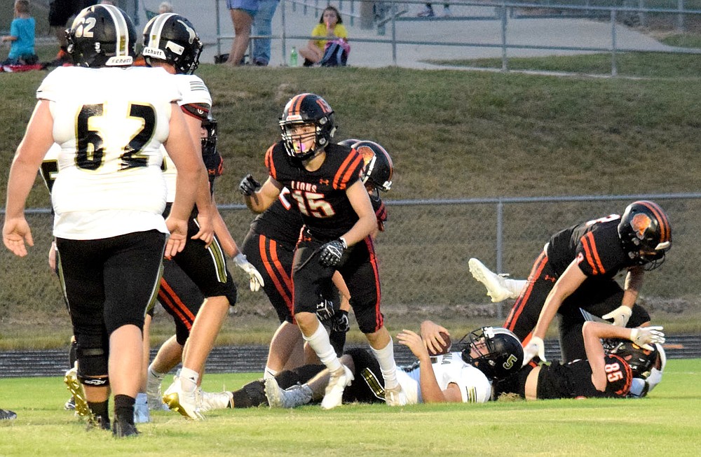Westside Eagle Observer/MIKE ECKELS
Lion Ryder Brown (15) gets off the ground after tackling the Longhorn quarterback in his own end zone for a Lion safety during the second quarter of the Gravette-Inola varsity football contest in Gravette Friday night. The safety put the Lions ahead of the Longhorns by one point going into the halftime break.