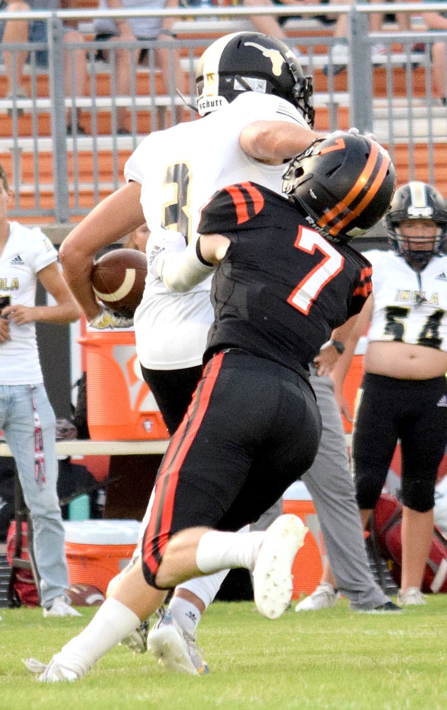 Westside Eagle Observer/MIKE ECKELS
Mason Meeker (Gravette 7) latches onto a Longhorn running back in an effort to prevent a sizable gain for the Longhorns during the second quarter of the Gravette-Inola, Oklahoma football contest Friday night in Gravette.