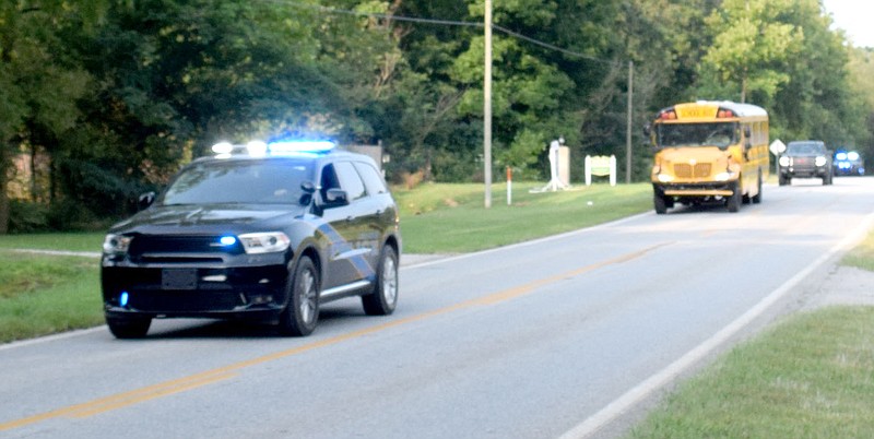 Westside Eagle Observer/MIKE ECKELS
Corporal Lance Dixon with the Decatur Police Department escorts the Decatur junior and senior high football teams to Centerton Friday morning. The Decatur teams departed the city on their way to Spring Hill for the second eight-man football contest of the 2021 season.