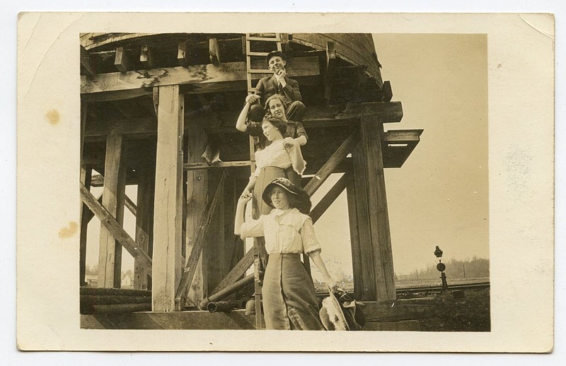 Harrison, 1914: The four ladies, and one pleased young man at the top had posed on the ladder of a water tower.