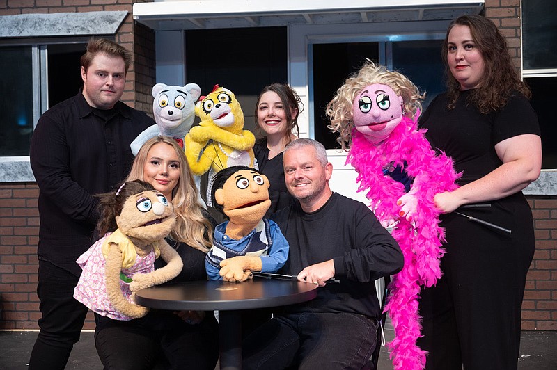 “Most puppets have two rods to work both arms,” explains Lexie Edmunds, who plays Kate Monster in the Arkansas Public Theatre production of “Avenue Q.” “When I get in the zone, and can move Kate — my new bestie — how I want, with ease, it’s a great feeling.” Pictured clockwise are Edmunds (seated left), Edward Mountz, Mary Maxwell, Rachel Lynn Mills and (seated right) Kenny Timbrel, who plays Princeton. (Special to the Democrat-Gazette/Chad Wigington for Arkansas Public Theatre)