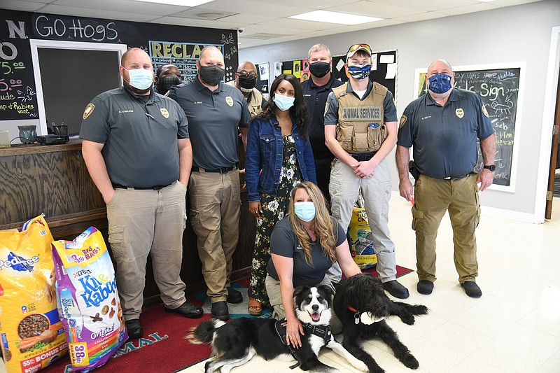 Michelle Stone, front, Hot Springs Animal Services coordinator, with dogs Jazzy, left, and Loki, with the staff of Animal Services, who are collecting donations for pets affected by Hurricane Ida. - Photo by Tanner Newton of The Sentinel-Record