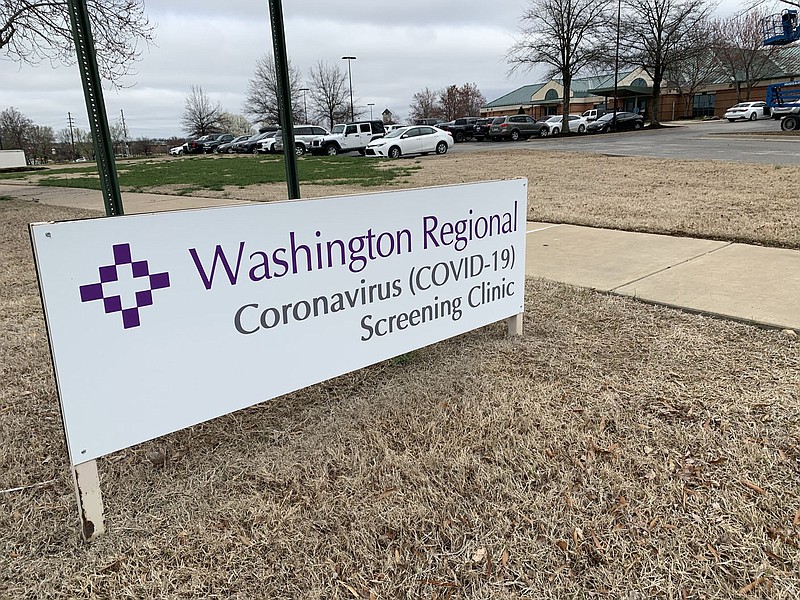 A sign stands March 17, 2020, to mark the entrance of a screening clinic operated by Washington Regional Medical Center at 3318 N. Northhills Blvd. in Fayetteville. The city's Board of Health on Wednesday heard from a physician at the covid-19 unit of the hospital on his experience with patients who said they had taken Ivermectin. (File photo/NWA Democrat-Gazette/Andy Shupe)