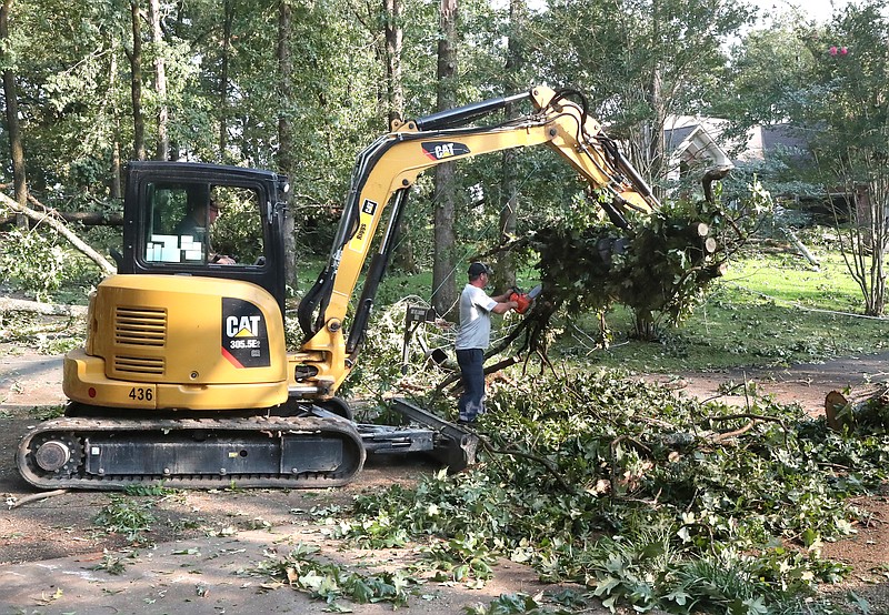Garland County employees work on removing downed trees on Windy Point Thursday. - Photo by Richard Rasmussen of The Sentinel-Record