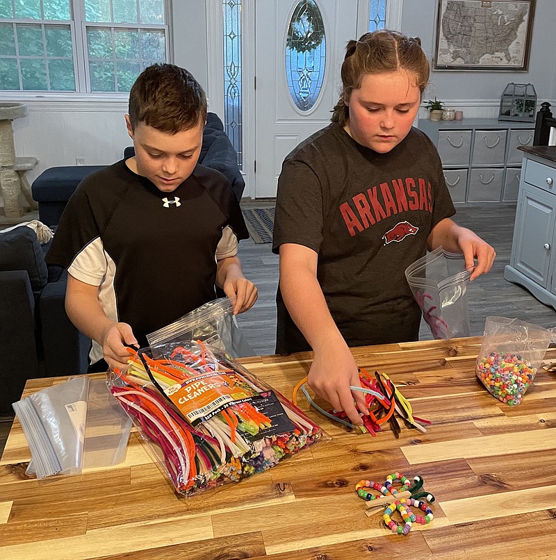 Cole and Emma Gulbransen work on a sample of the craft kits being made by local children from the Church of Jesus Christ of Latter-day Saints. As part of a project to remember Sept. 11, 2001, and “transform the anniversary into a worldwide day of unity and doing good,” the youngsters will donate the craft kits to Arkansas Children’s Hospital for patients there.

(Courtesy photo)