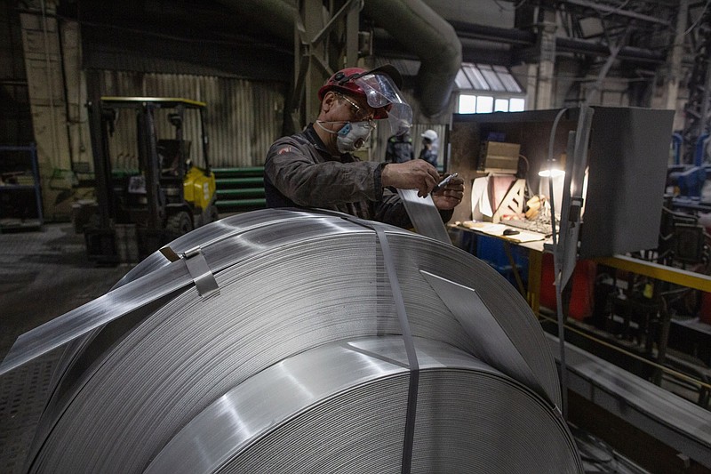 A worker labels rolls of sheet aluminium at the United Co. Rusal aluminium smelting plant in Shelekhov, Russia, on April 9, 2021. MUST CREDIT: Bloomberg photo by Andrey Rudakov.