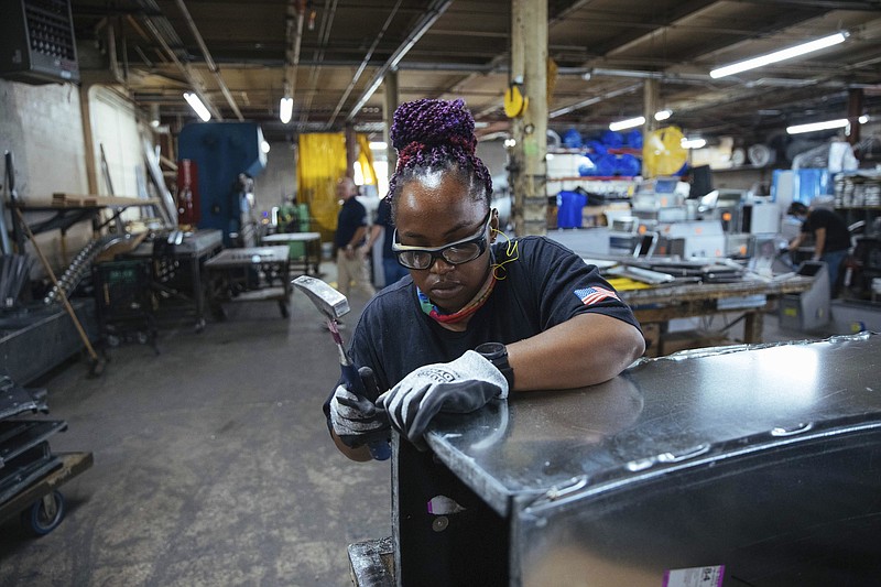 Sheet metal worker Carey Mercer assembles ductwork at Contractors Sheet Metal on Tuesday, Aug. 3, 2021, in New York. The construction industry is fighting to recruit more women into a sector that faces chronic labor shortages. Women make up only 4% of skilled construction laborers in the U.S. and often face discrimination on jobs sites.   (AP Photo/Kevin Hagen)