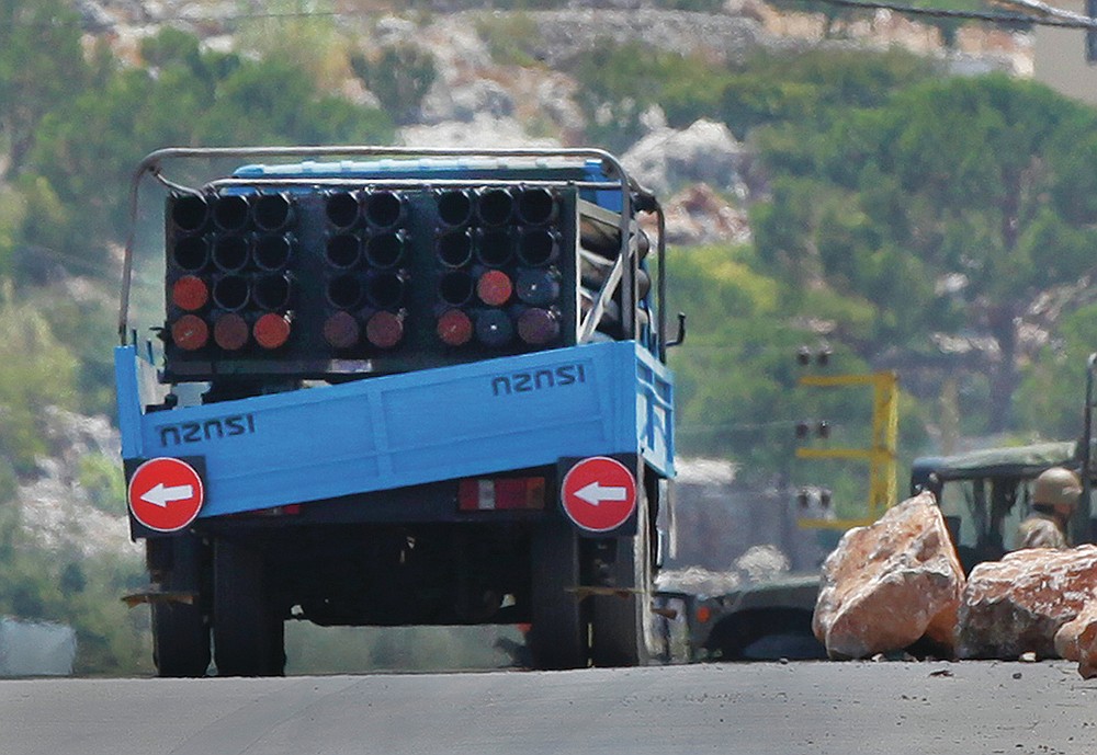 FILE - In this Aug. 6, 2021 file photo, a rocket launcher placed on a pick up truck that was used by Hezbollah to fire rockets near Israeli positions, is seen in the southeastern village of Shwaya, near the border with the Golan Heights, Lebanon. As Lebanon sinks deeper into poverty and collapse, many Lebanese are more openly criticizing the Iran-backed Hezbollah, blaming it for its role in the devastating, multiple crises plaguing the country. This includes a dramatic currency crash and severe shortages in medicines and fuel that has paralyzed the country. (AP Photo/Mohammed Zaatari, File)
