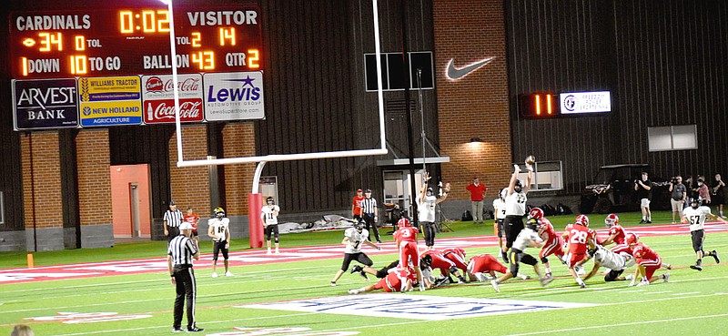 MARK HUMPHREY  ENTERPRISE-LEADER/Farmington senior Luis Zavala (No. 28) kicks a 35-yard field goal as time expires in the first half to cap 16 points scored by the Cardinals in the last minute of the second quarter. The surge fueled Farmington's 56-27 rout of rival Prairie Grove in front of a capacity crowd at Cardinal Stadium Friday.