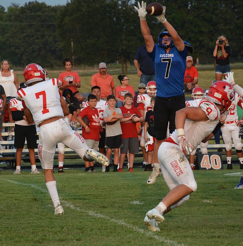 Graham Thomas/Siloam Sunday
Colcord's Eyan Williams (right) goes high in the air to bat down Kansas quarterback Ty Lewis' pass during the first quarter of Thursday's game between Delaware County rivals Kansas and Colcord. Colcord defeated Kansas 39-12.