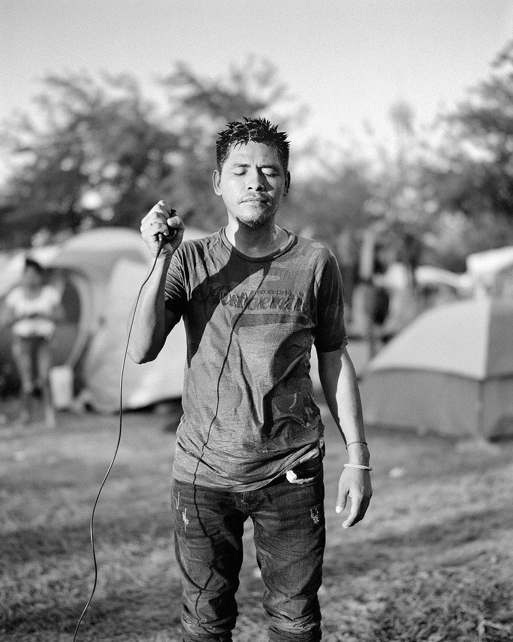 Adam Ferguson, Linifir L?pez, 33, informal migrant camp, Reynosa, Mexico, 2021, 60 x 48 inches, archival pigment print, courtesy of the artist. this image is part of Migrantes, an exhibit at Windgate Museum of Art at Hendrix college DO NOT CROP