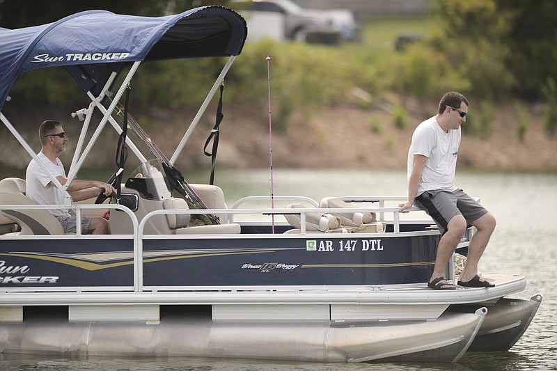 Wesley Smithson of Rogers (from left) and Christian Galbavi of Centerton return to dock after a day of fishing, Friday, September 3, 2021 at the Prairie Creek Marina in Rogers. Check out nwaonline.com/210904Daily/ for today's photo gallery. 
(NWA Democrat-Gazette/Charlie Kaijo)